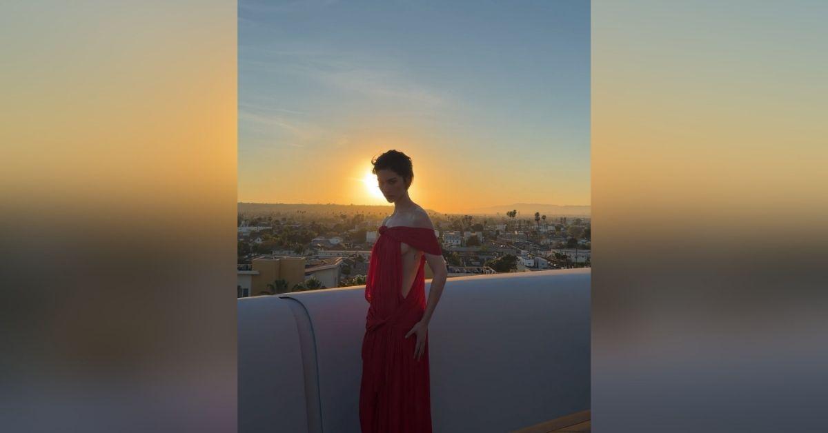 image of Gracie Abrams shared a new Instagram carousel featuring a bold crimson cutout gown that stood out against a stunning Los Angeles sunset.