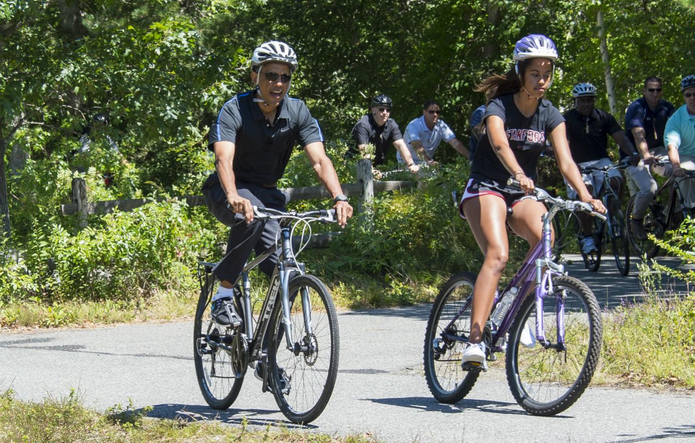 Malia and Barack Obama go for a ride on one of their many trips to Martha's Vineyard.