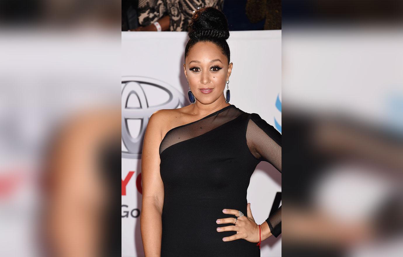 Tamera Mowry Wearing Bun And One Sleeve Dress On red Carpet