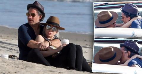 Lady gaga boyfriend christian carino pack on pda beach