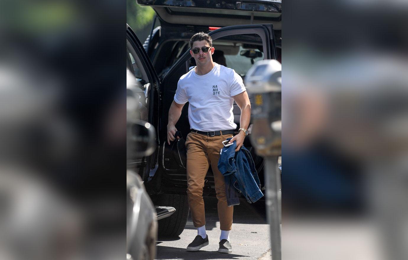 EXCLUSIVE: Nick Jonas sports a mustache as he arrives at a studio