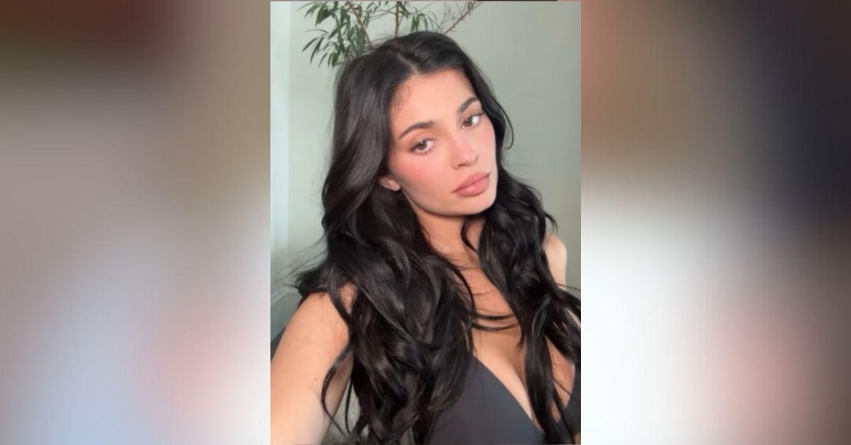 image of Kylie Jenner posted a sultry makeup video in a black bra and leggings.