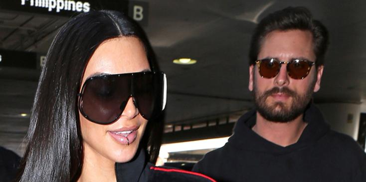 Kim Kardashian draws a crowd at LAX with Scott Disick