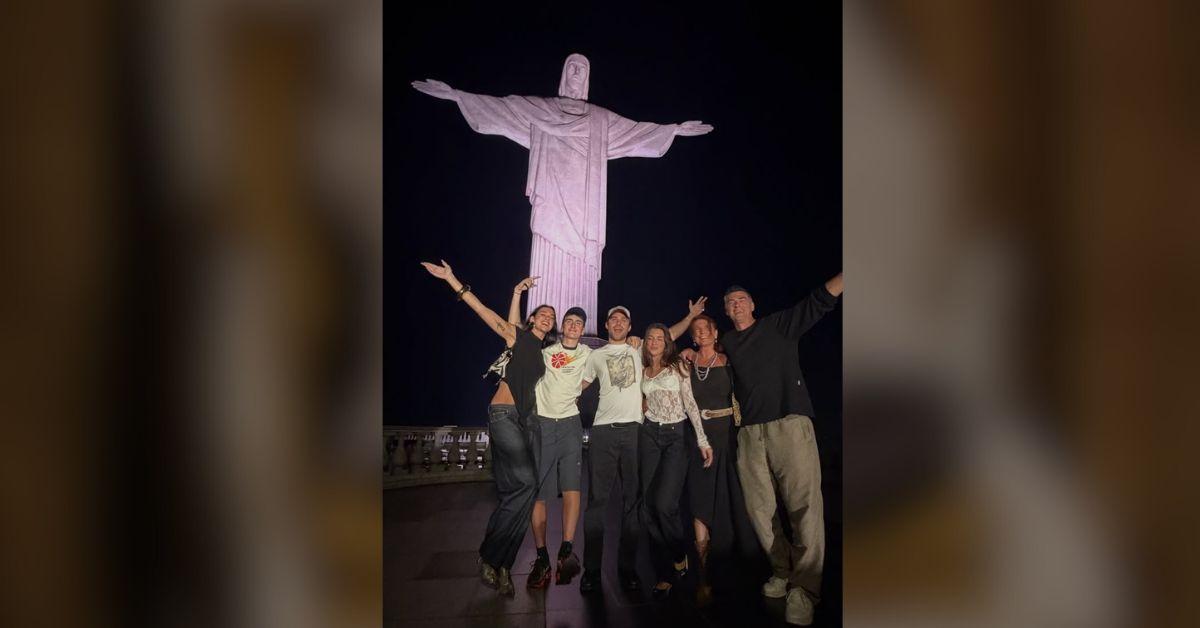 image of Dua Lipa and her friends posed next to the Christ the Redeemer statue.