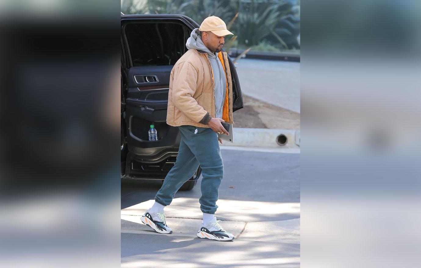 Kanye West greets our shutterbugs with open arms!