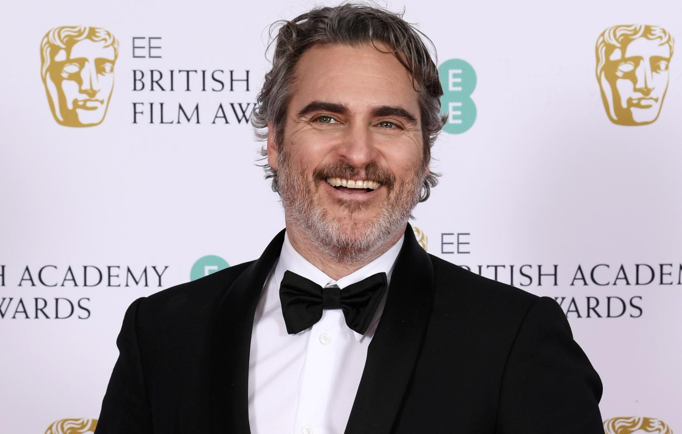 Joaquin Phoenix proudly held his BAFTA while he wore a traditional black tux with a black bow tie.