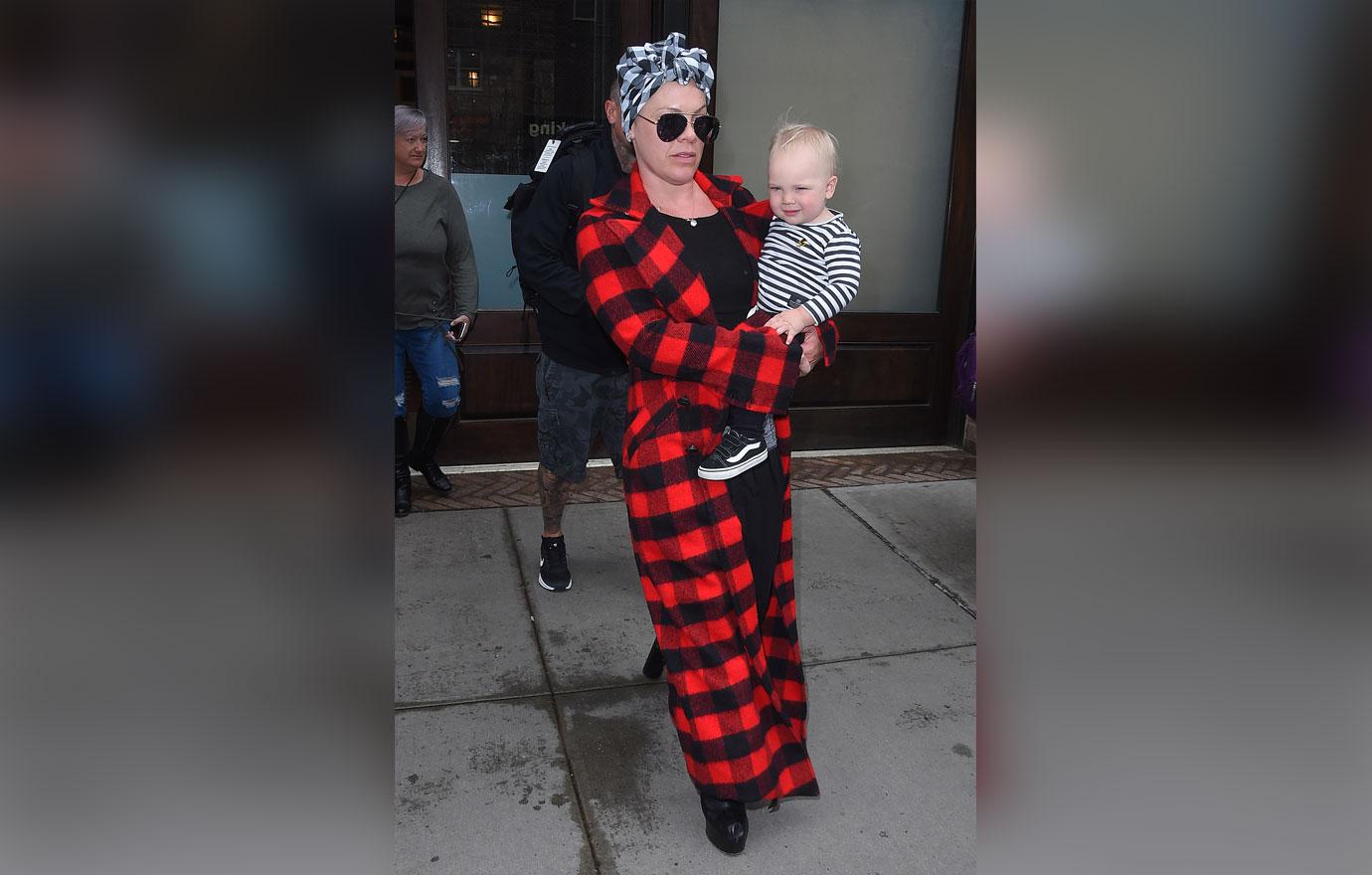 Pink Wearing Plaid Jacket With Child In Her Hand