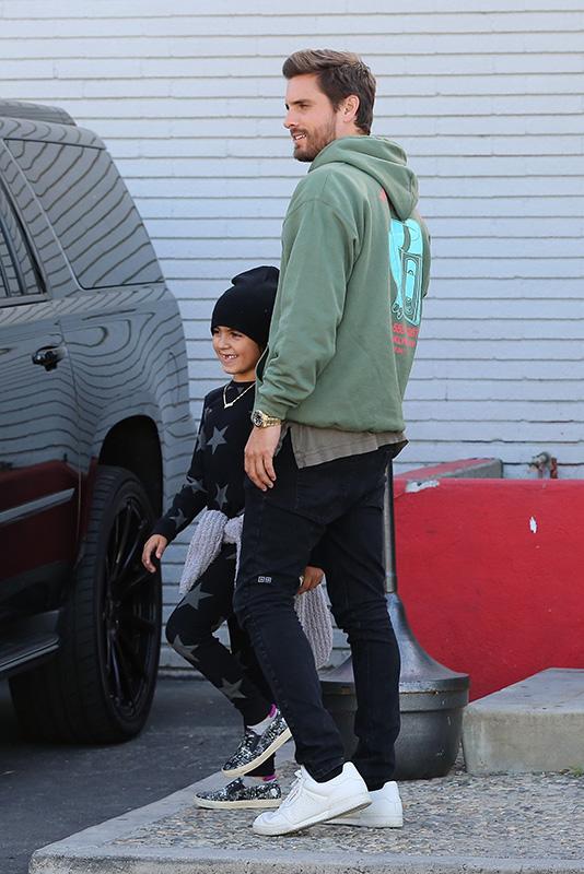 Kourtney Kardashian grins from ear to ear as she leaves the bowling alley with her family