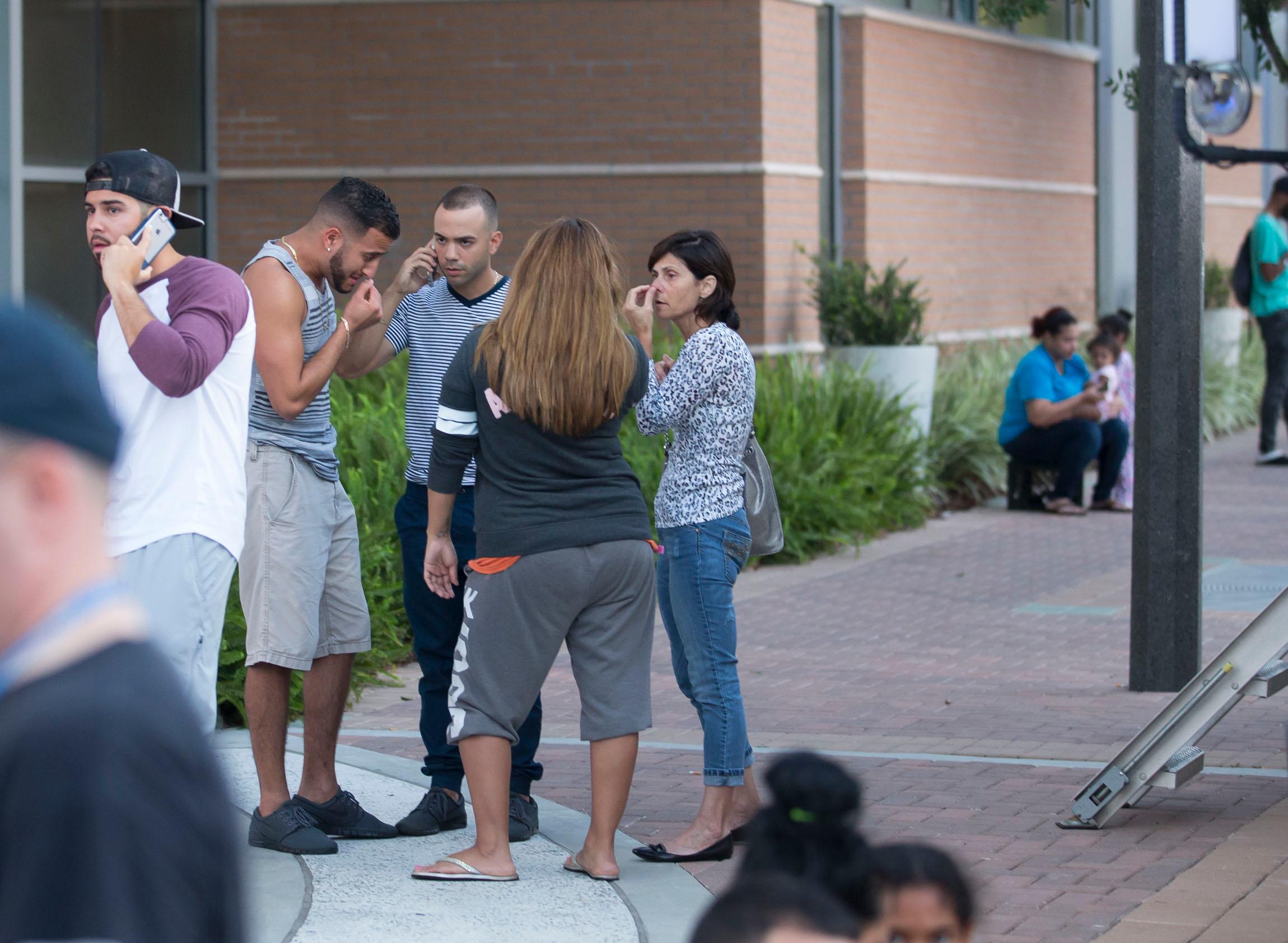 Orlando mass shooting at Pulse nightclub. Police block roads, people wait at hospital.