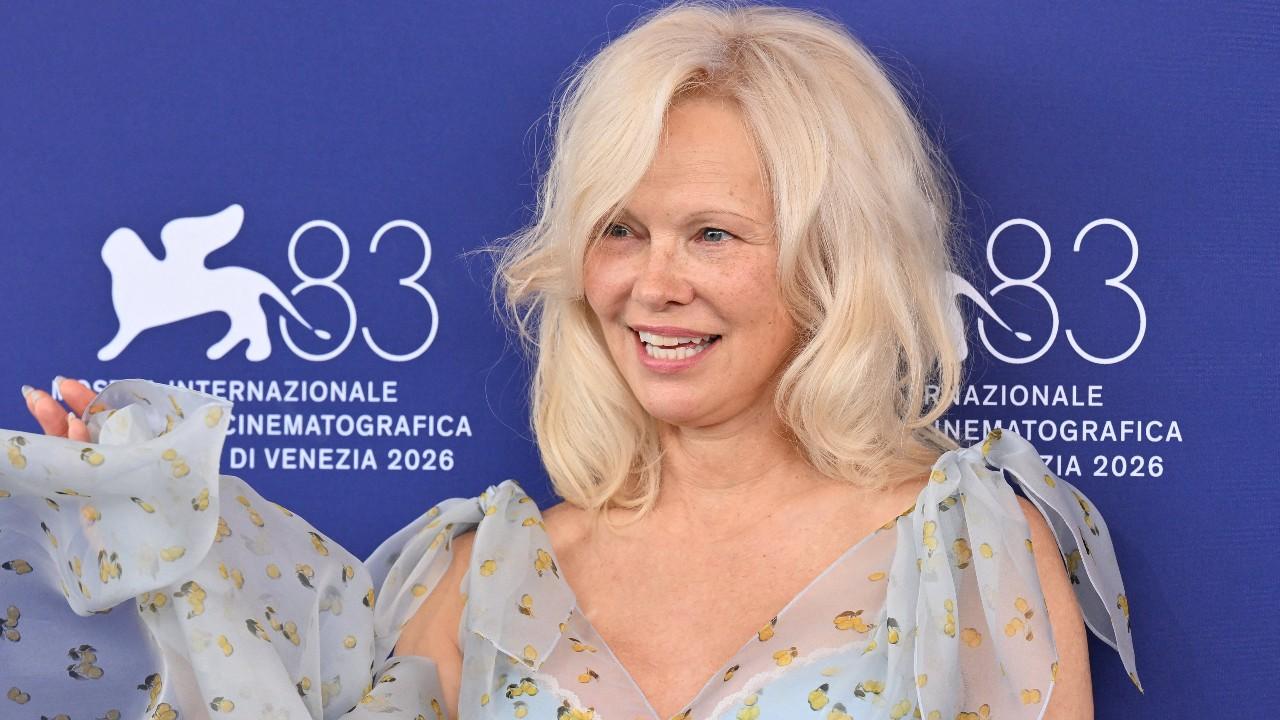 Image of Pamela Anderson stepped out in a custom pale-blue Monse dress covered in a whimsical pear print.