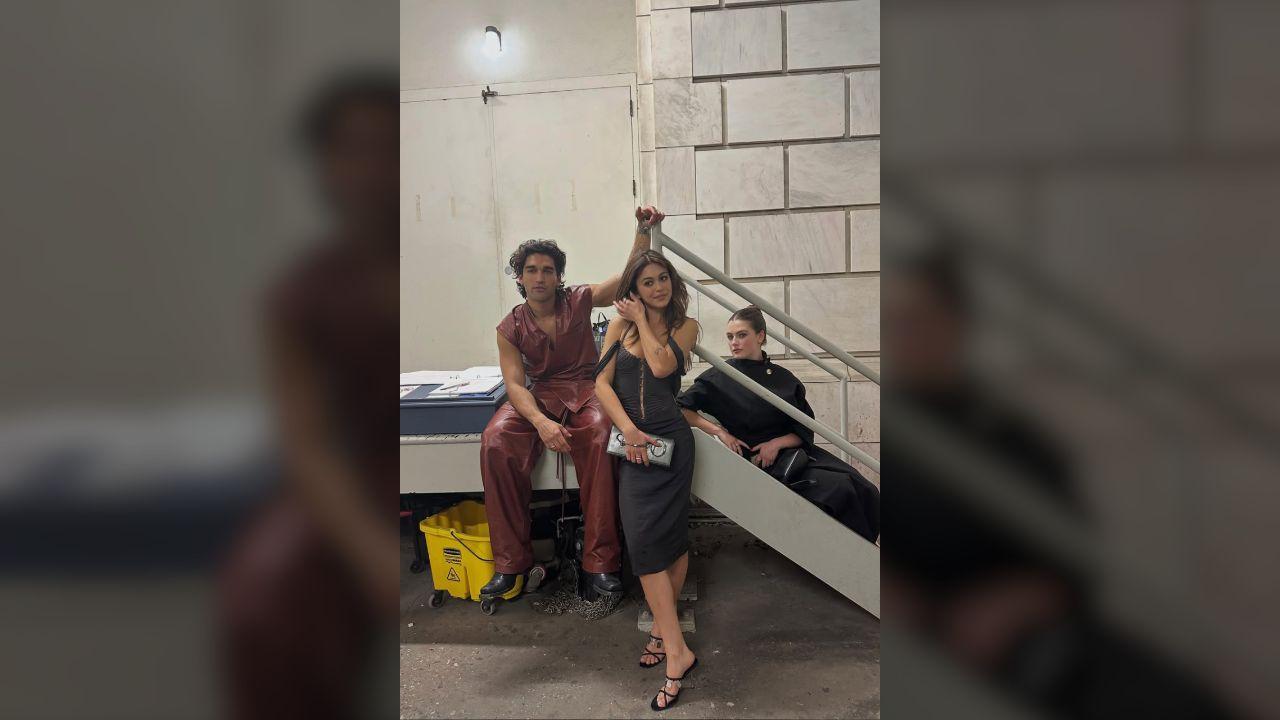 Photo of Mika Abdalla and Josh Heuston held hands at PFW.