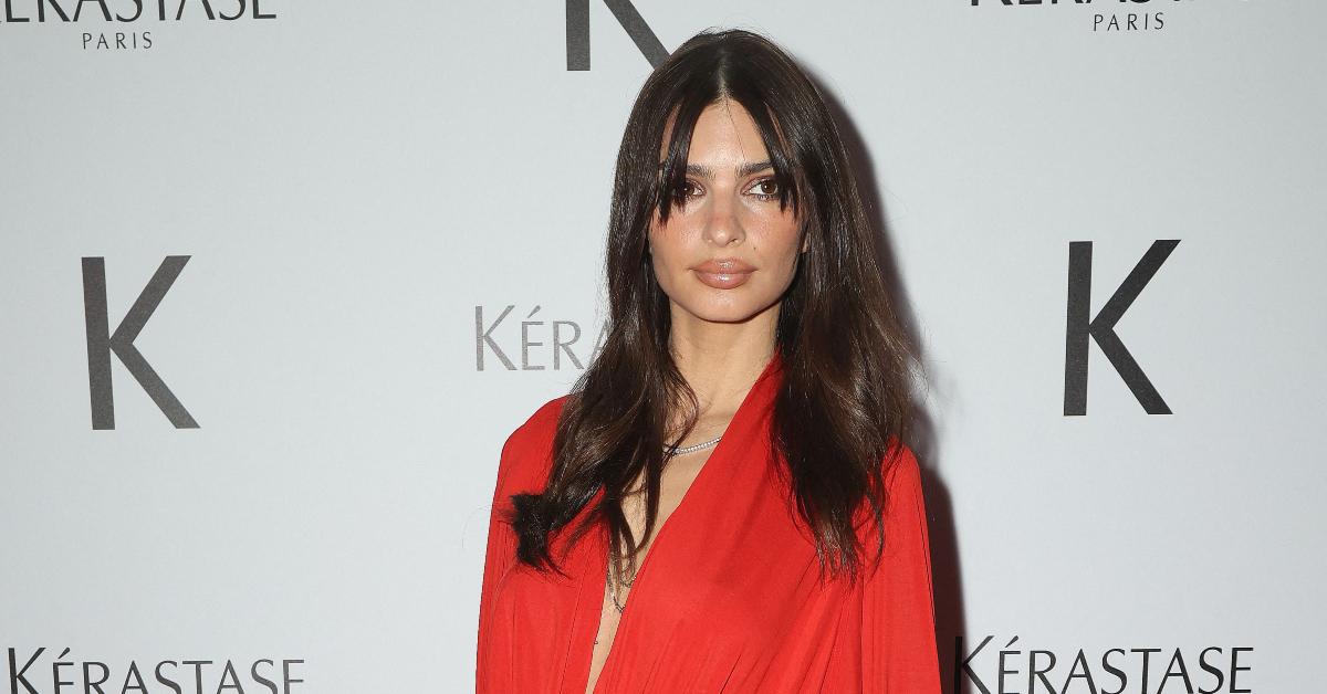 Emily Ratajkowski barely covers her boobs as she poses topless in