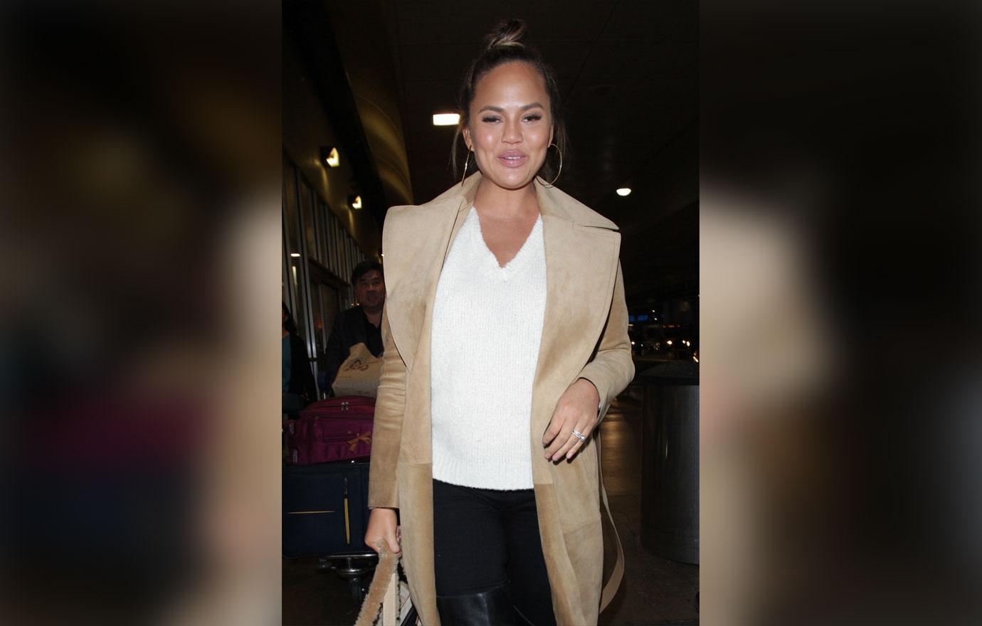 Chrissy Teigen warms up as she dashes to her flight