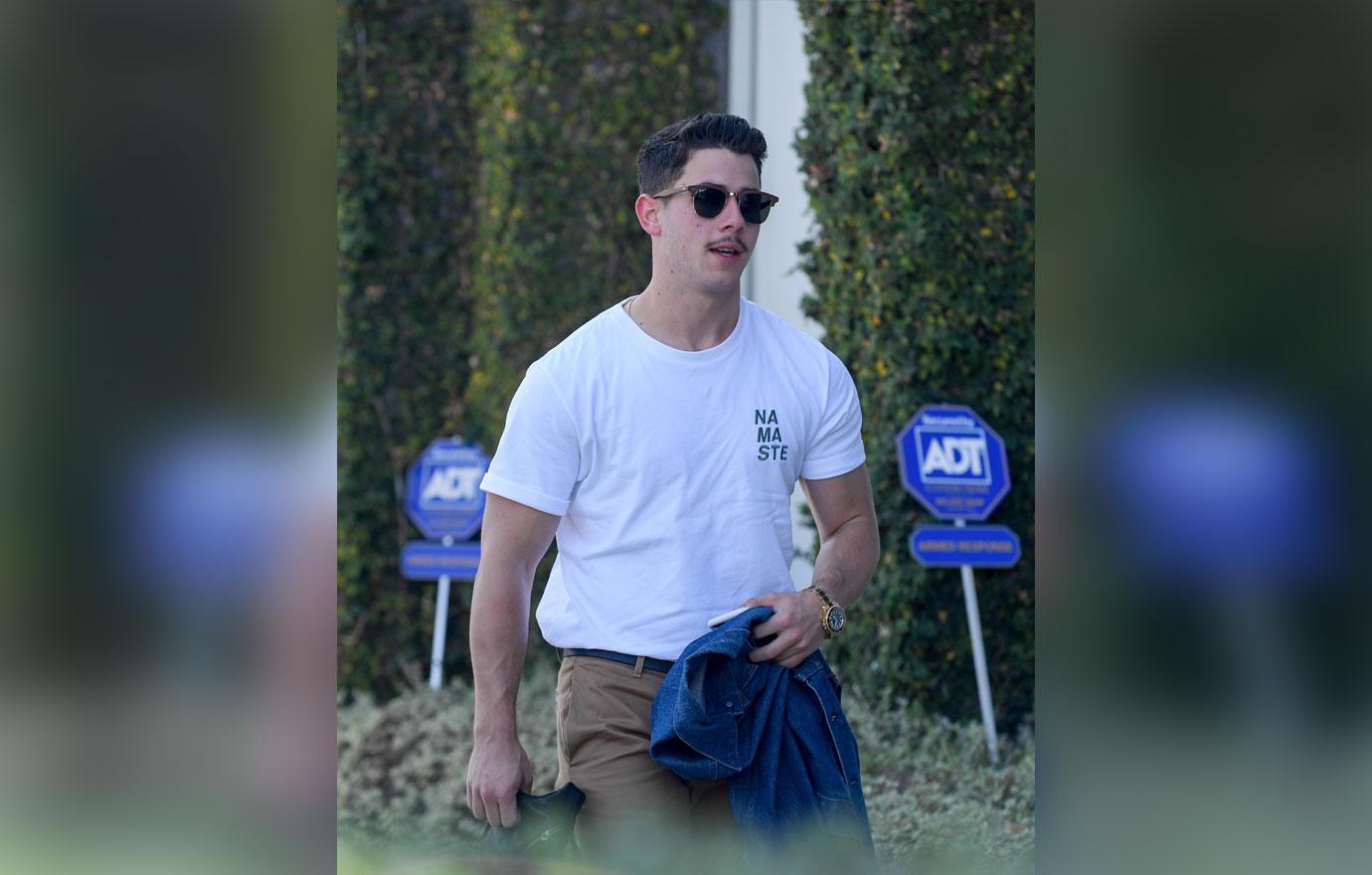 EXCLUSIVE: Nick Jonas sports a mustache as he arrives at a studio