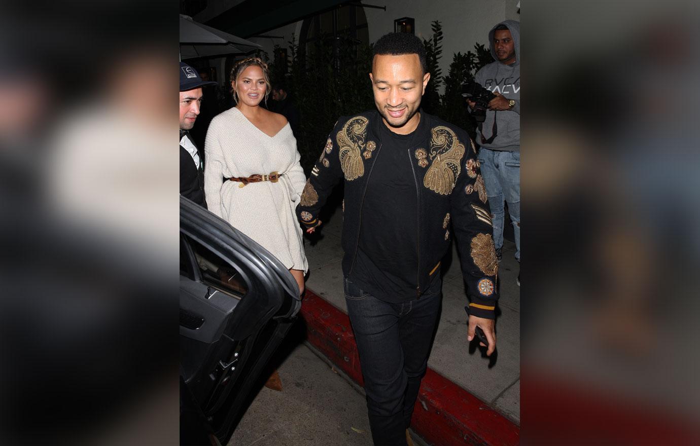 Chrissy Teigen and John Legend hold hands as they leave Madeo restaurant after having a romantic dinner