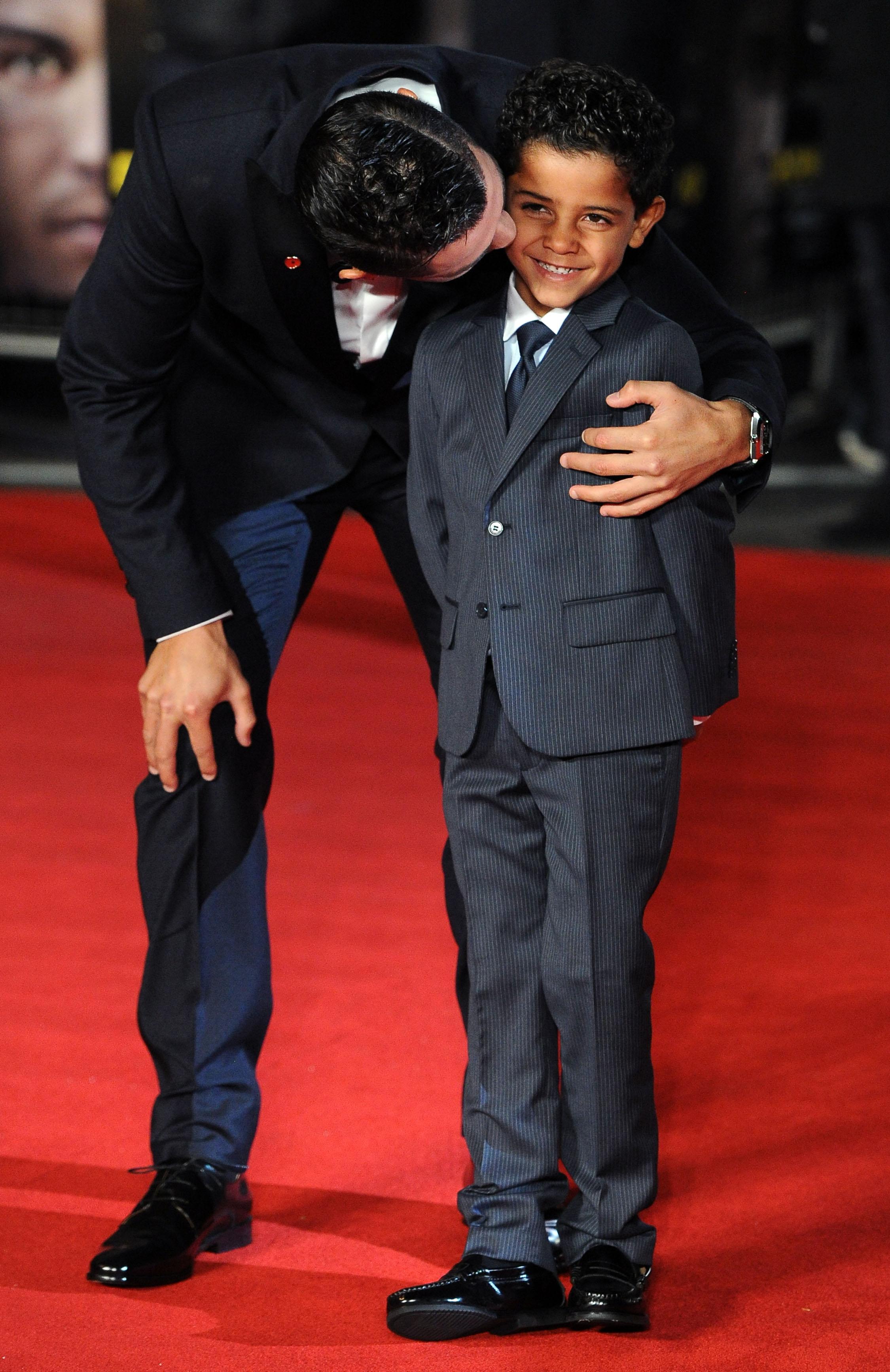 Cristiano Ronaldo kisses his son and poses with Sir Alex Ferguson and several guests at the world premiere of &#8216;Ronaldo&#8217; in London