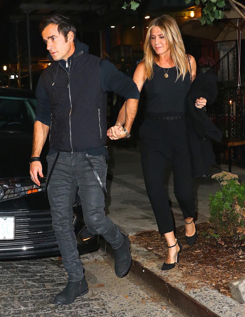 Justin Theroux and Jennifer Aniston hold hands as they head out after dinner