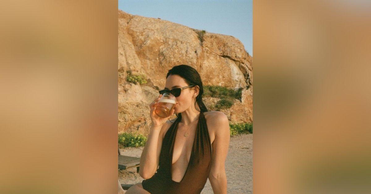 image of The actress wore a brown swimsuit and sipped wine.
