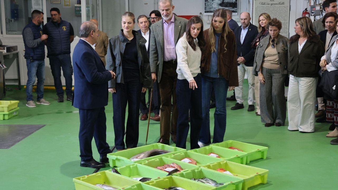 Image of for the royal engagement, the king wore a pink buttoned shirt, olive pants, and a gray blazer with tan dress shoes.
