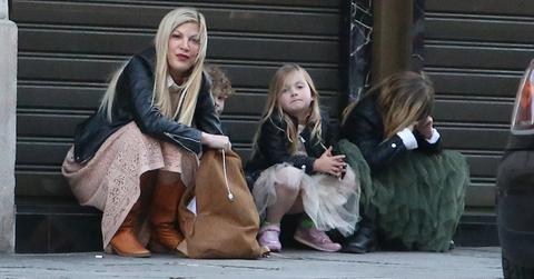 Tori Spelling waiting for taxi in Paris with kids