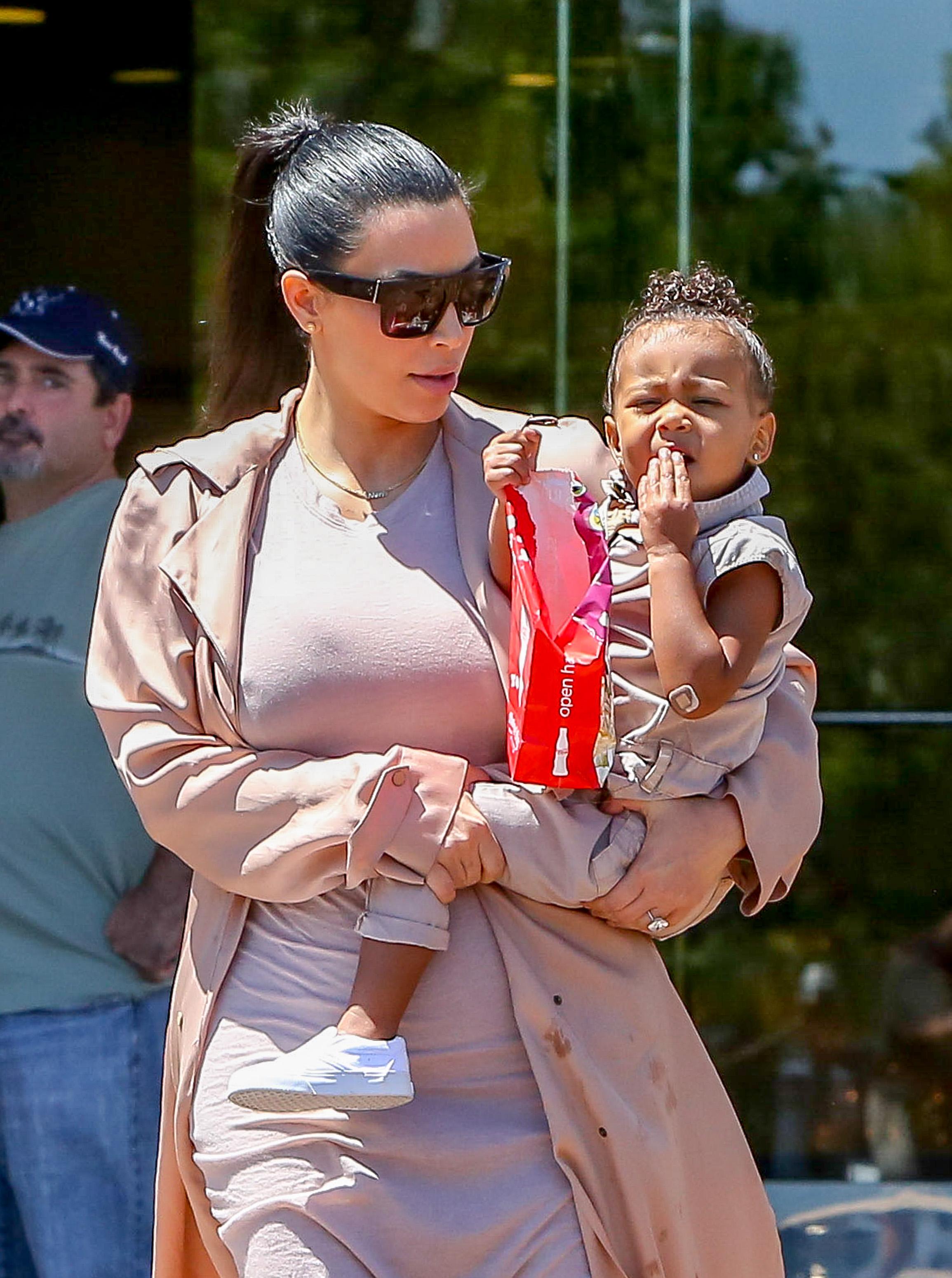 Kim Kardashian and Kanye West take their baby North West to the movies in Calabasas, CA