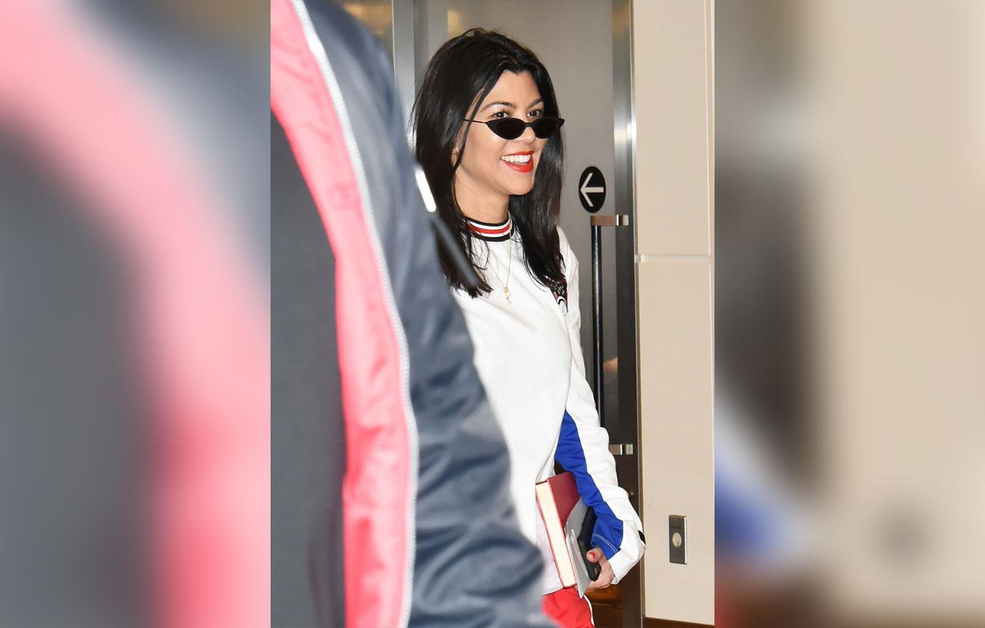 Pink haired Kim Kardashian and sisters Kourtney and Khloe Kardashian land in Tokyo