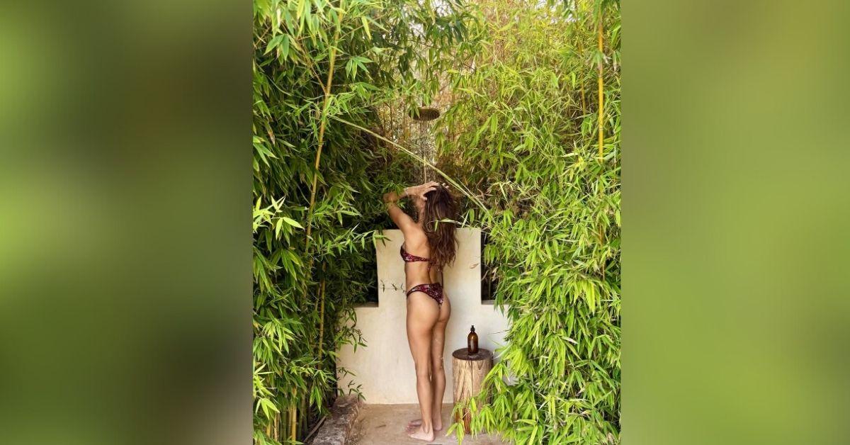 image of The former Victoria's Secret angel flaunted her backside as she took a shower outdoors.