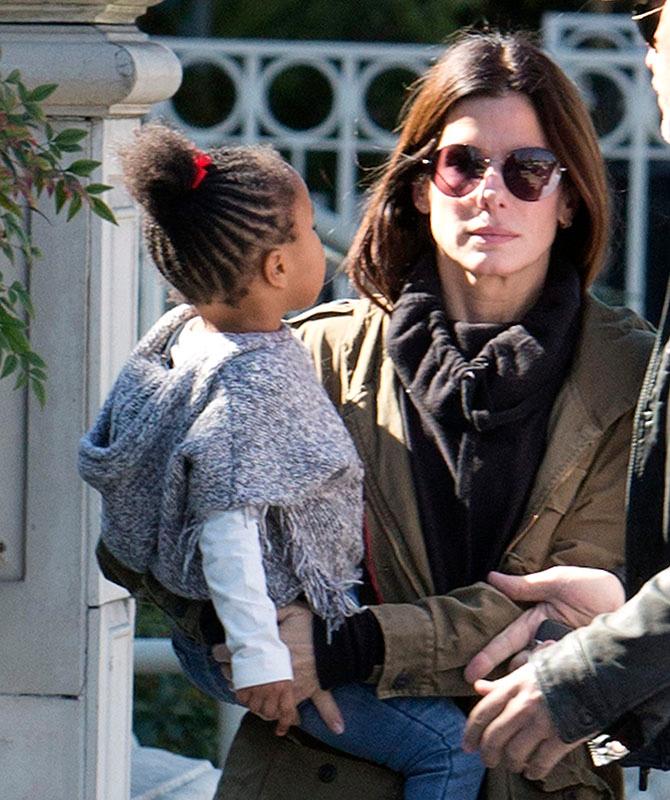 EXCLUSIVE: *** Premium Exclusive Rates Apply*** Sandra Bullock doesn&#8217;t look to impressed with boyfriend Bryan Randall as she holds her daughter Laila while they pick up coffee in Studio City, CA