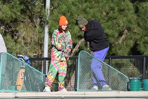 vanessa hudgens and her boyfriend cole tucker hit the driving range on new years eve