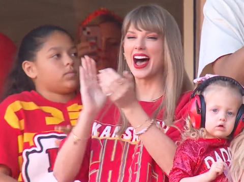 Taylor Swift & Travis Kelce Hold Hands While Leaving Chiefs Game