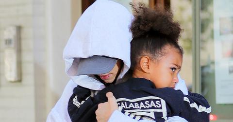 Kim Kardashian runs fearfully to her waiting SUV with a scared looking North West in New York