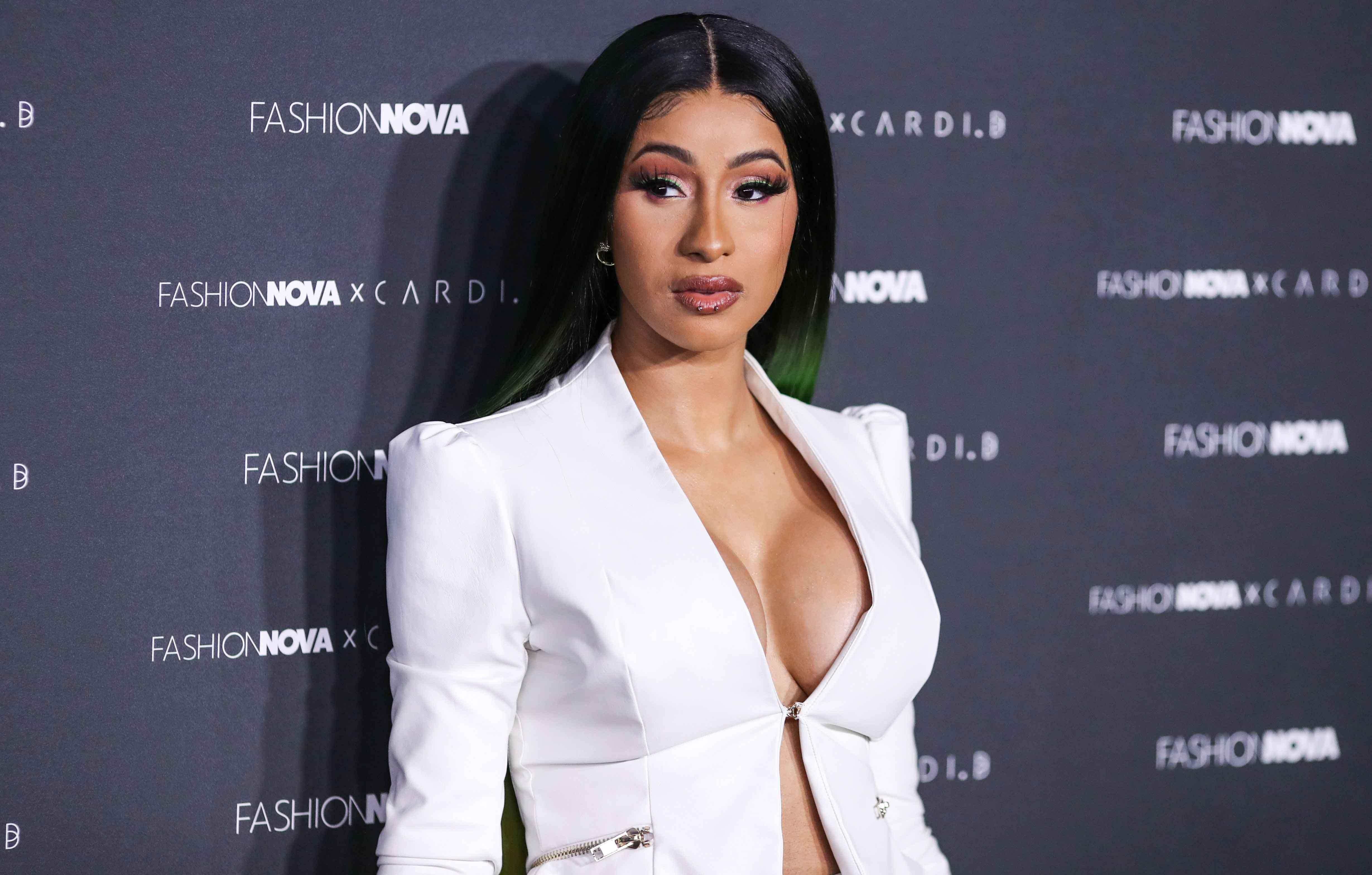 Check Out: Cardi B Posts a Series of Images Wearing a Skintight White Dress  at the poolside