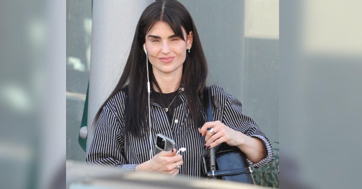 image of The singer wore a stripped shirt and cute black bag for her day.