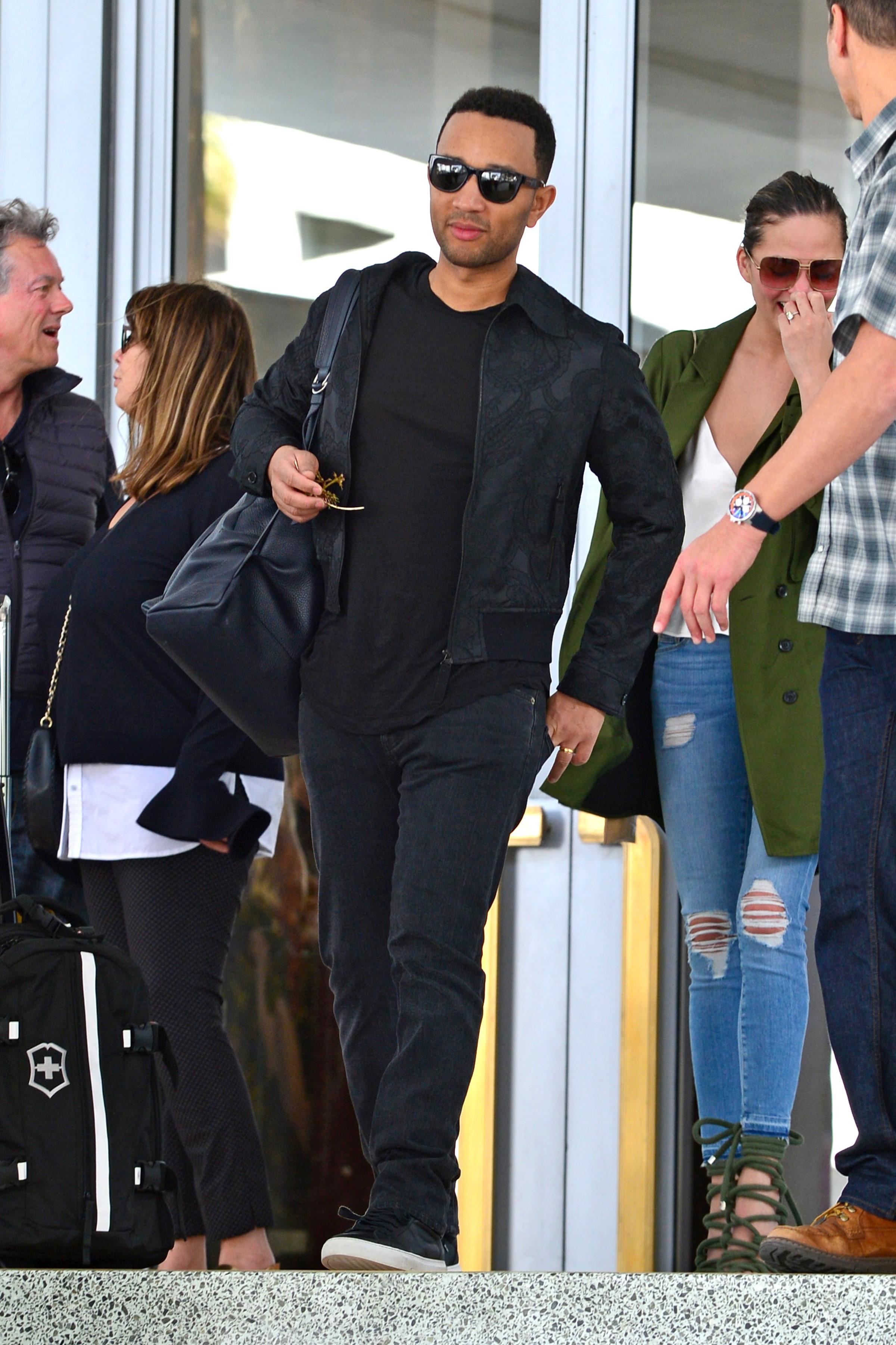 John Legend and Chrissy Teigen head to the airport