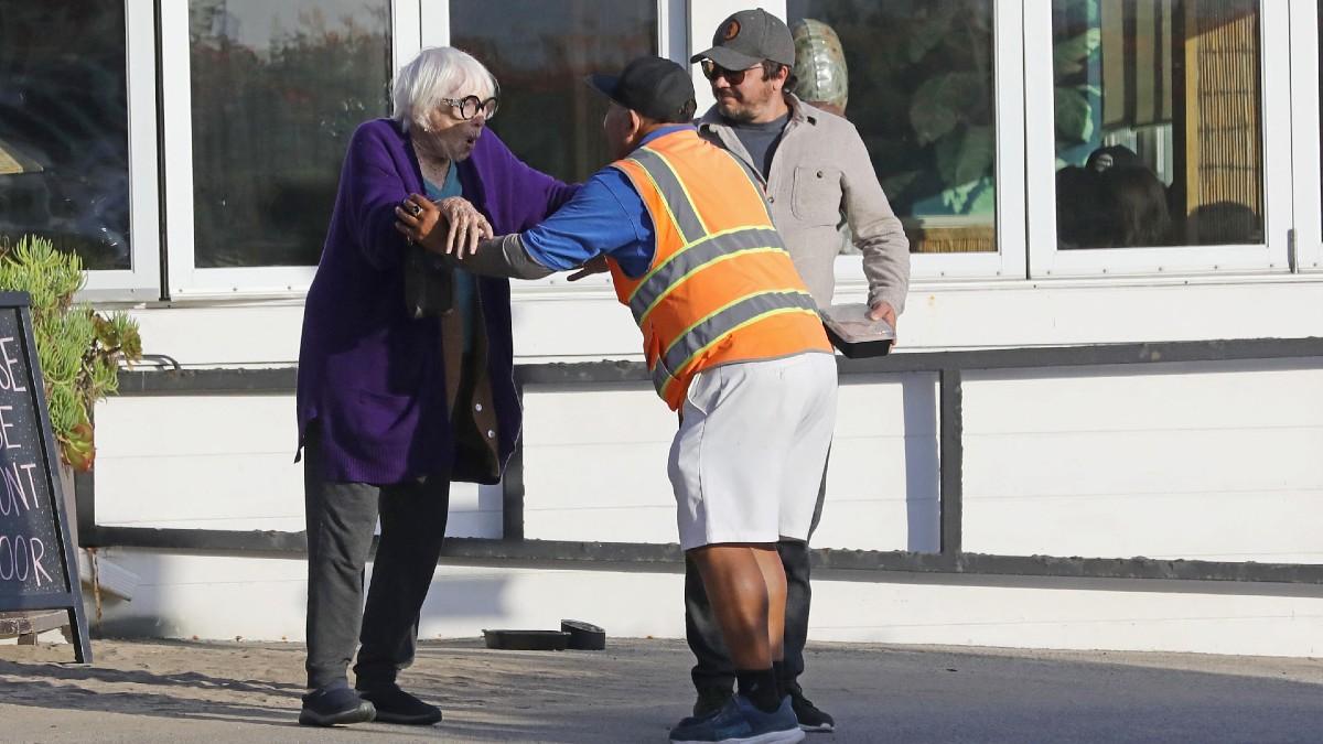 Photo of The pair was met with additional help to assist the movie star to her vehicle. 