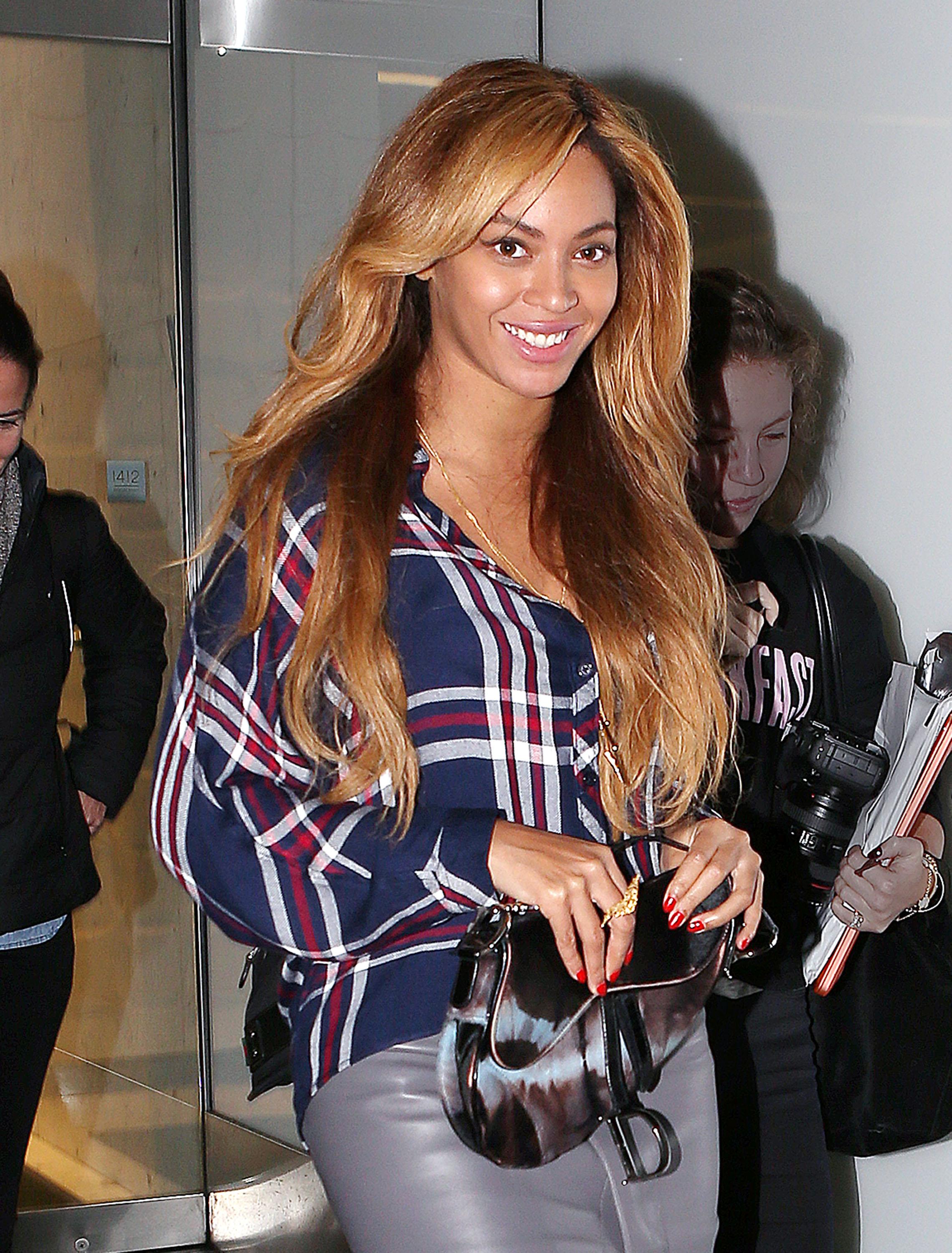 Beyonce out and about in NYC wearing a tartan top and leather skirt