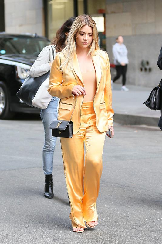 Ashley Benson stands out in a golden orange satin outfit