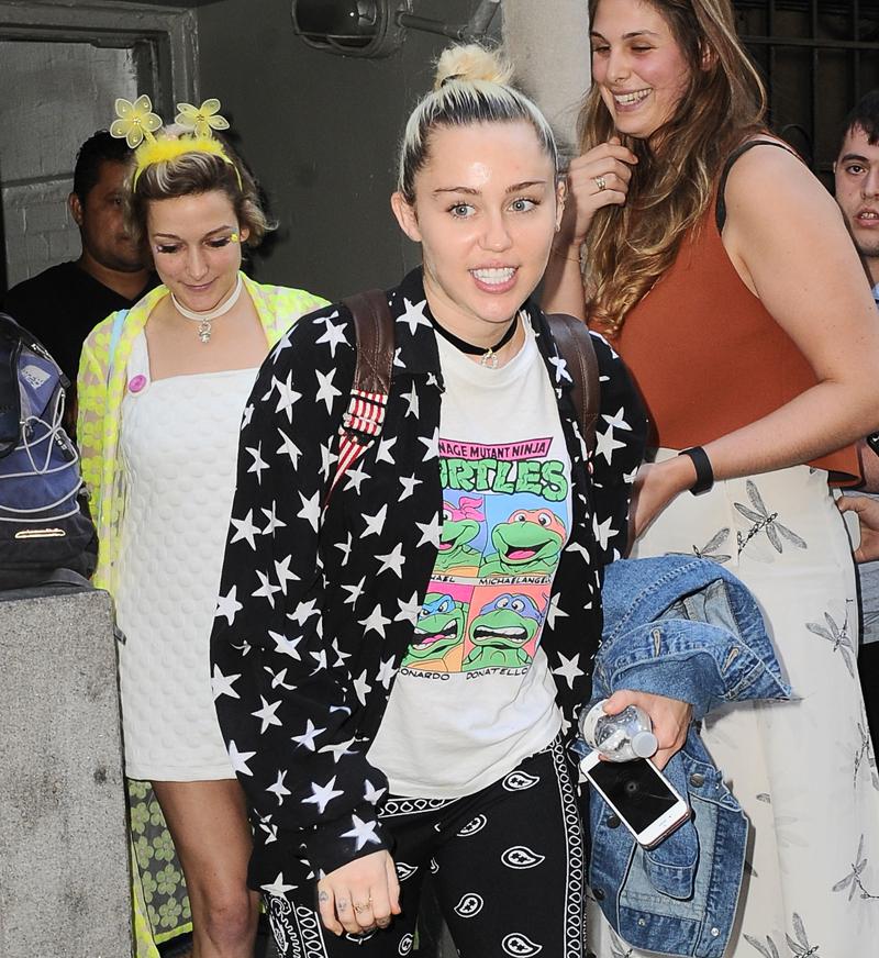 Miley Cyrus is all smiles as she steps out wearing a funky outfit in NYC