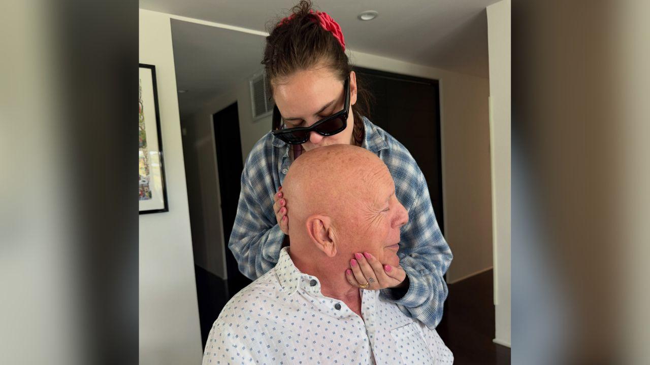Image of Tallulah Willis leaned over to kiss her famous dad on the head during what she called a 'Sunday funday at Papa's.'