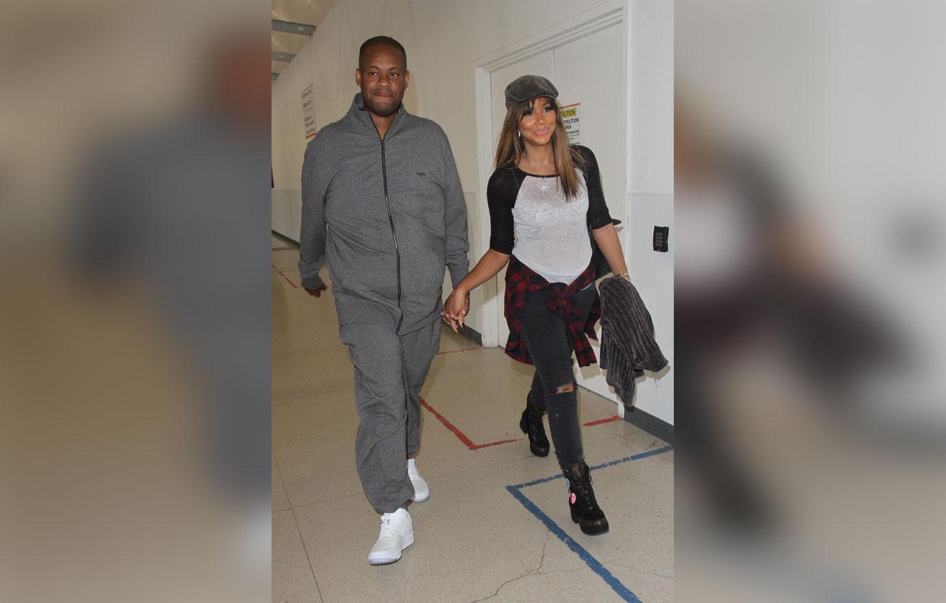 Tamar Braxton and Vincent Herbert depart LAX with their hands locked