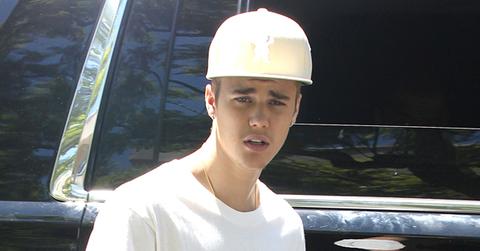 Justin Bieber waves to fans outside his house