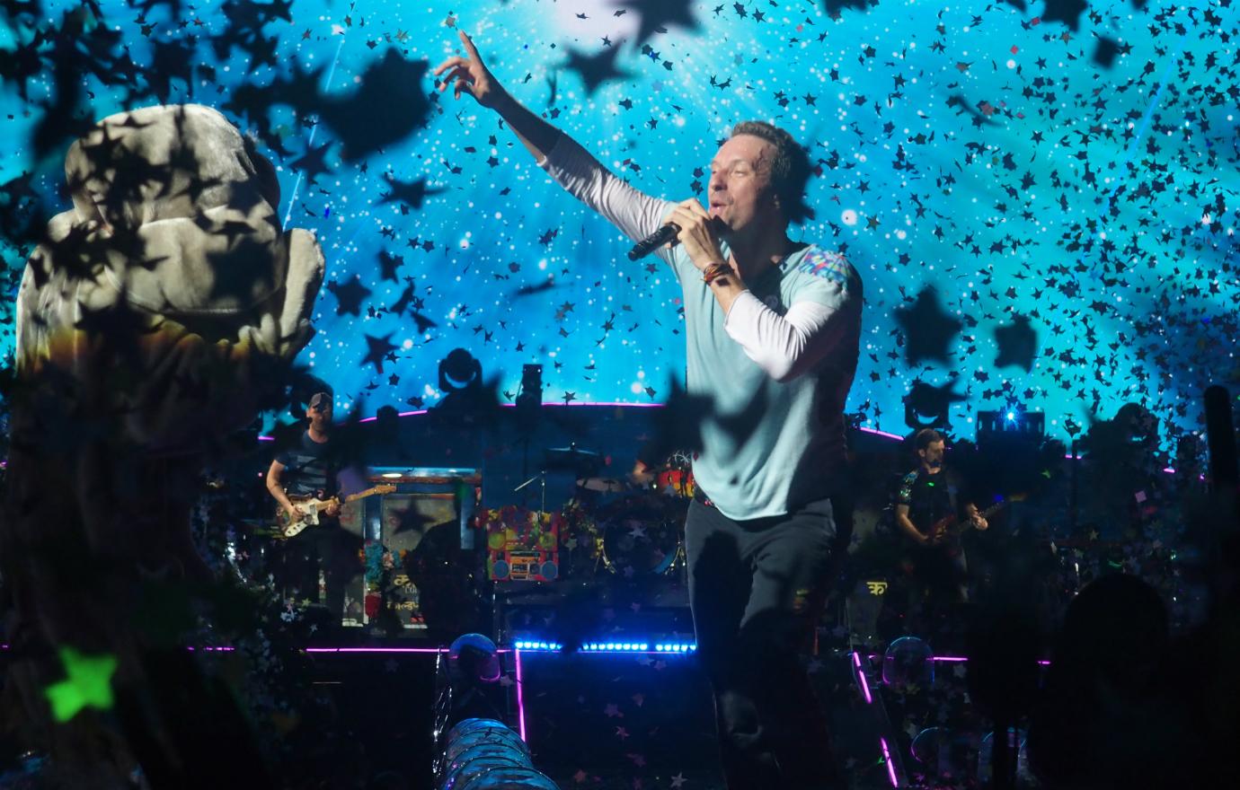 Chris Martin rocks with his band Coldplay, while girlfriend Dakota Johnson watched from the sound booth.