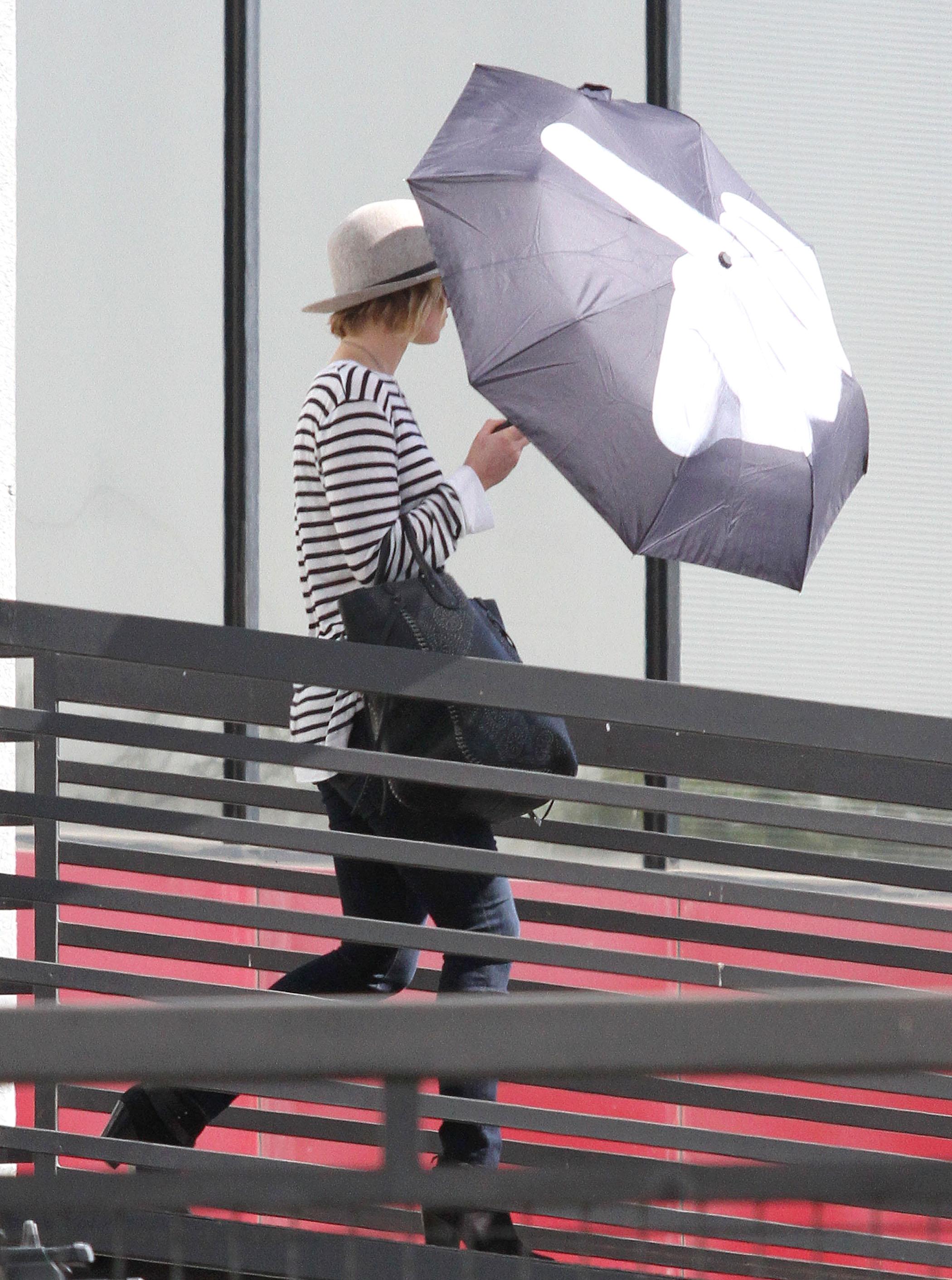 Jennifer Lawrence shows the photographers the middle finger through her new umbrella while visiting Rachel Zoe&#8217;s office in West Hollywood