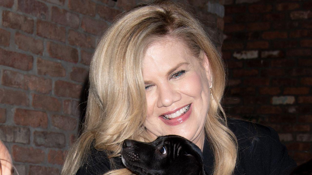Image of Johnston holding a dog.