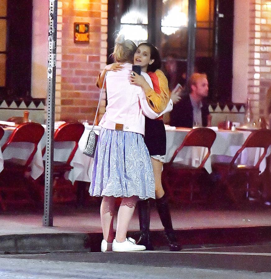 EXCLUSIVE: Elle Fanning sits on a curb and chats with a friend after dinner at Little Dom&#8217;s in Los Feliz, CA.