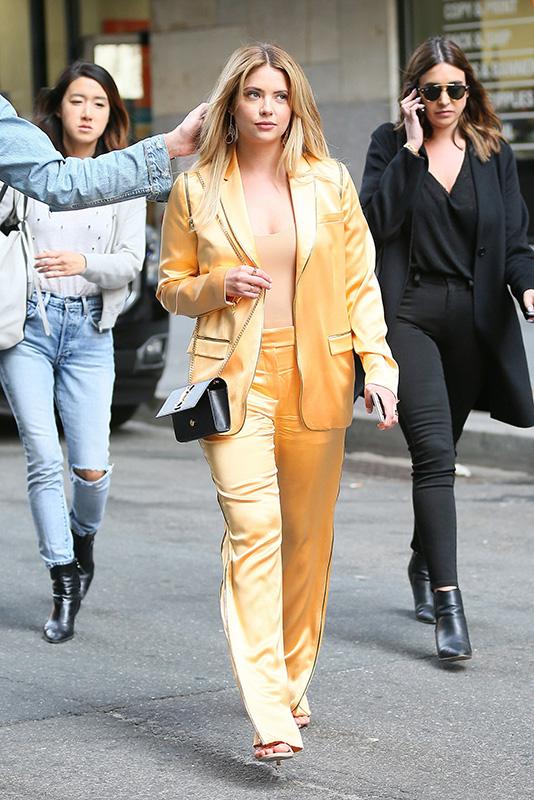 Ashley Benson stands out in a golden orange satin outfit