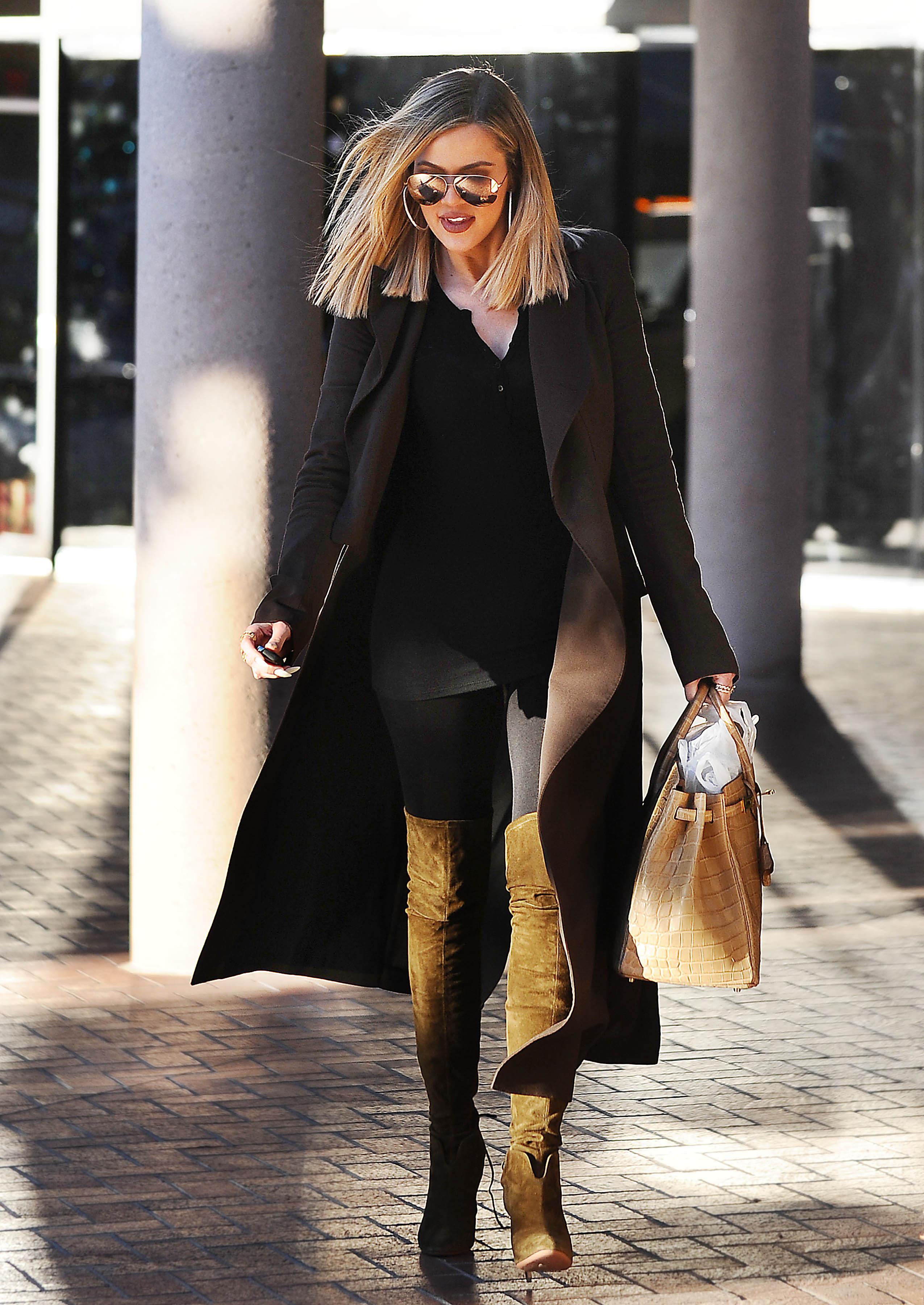 Khloe Kardashian leaves her attorneys office in knee high suede boots