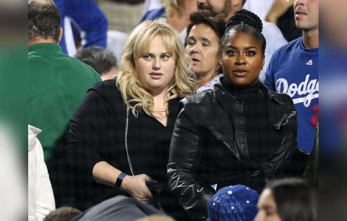 Actor Will Ferrell, at podium, points toward Los Angeles Dodgers