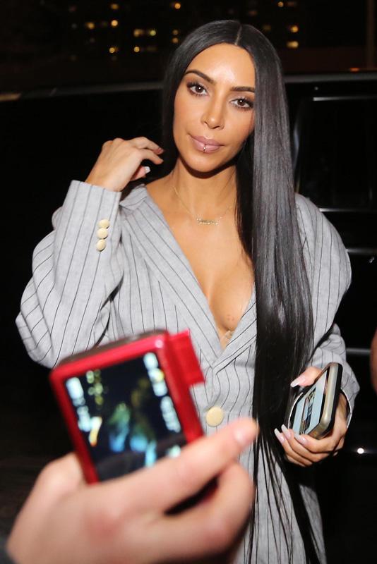 Kim Kardashian almost suffers a wardrobe malfunction while being greeted by fans