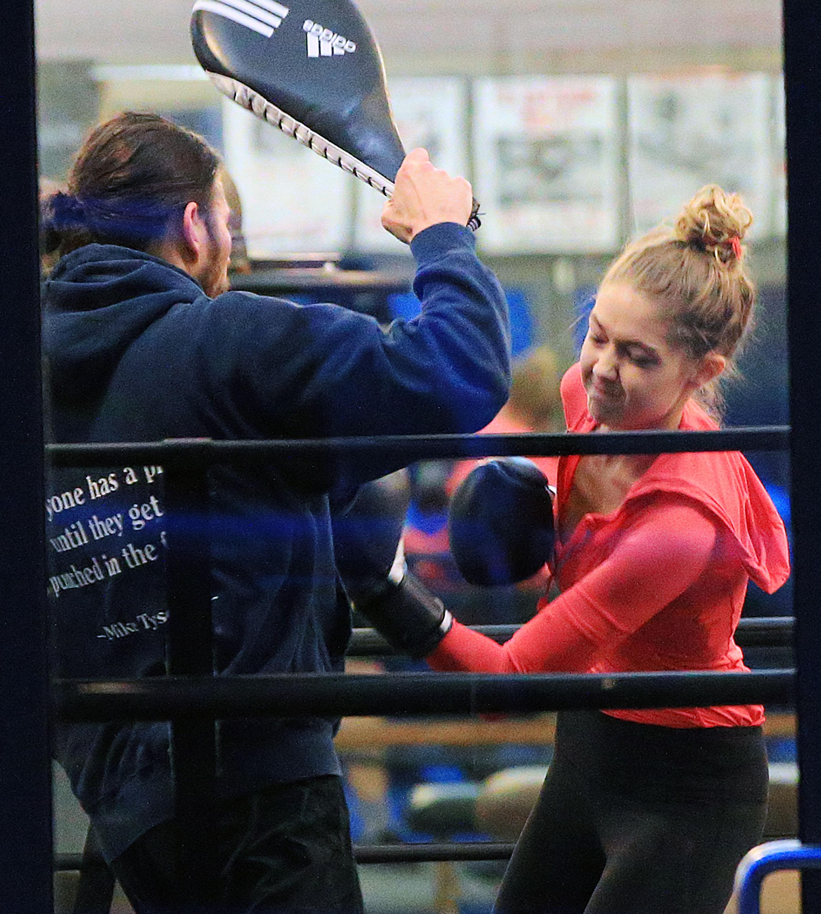 Gigi Hadid lands an uppercut on  her trainer at the boxing gym during a workout in NYC